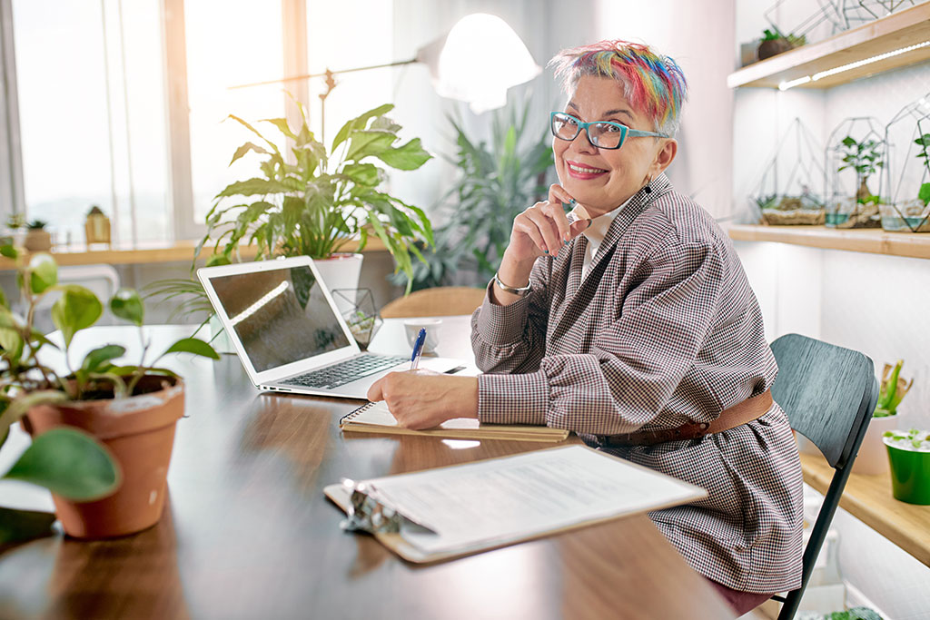 New business mature woman working on her laptop