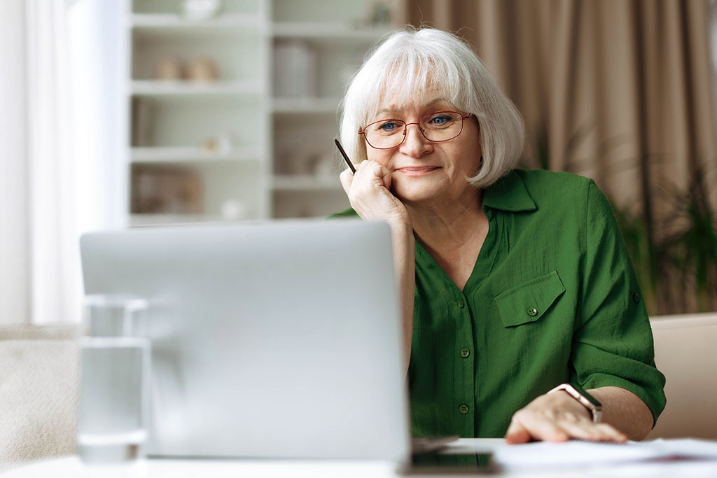 Woman looking contently at the screen on her computer
